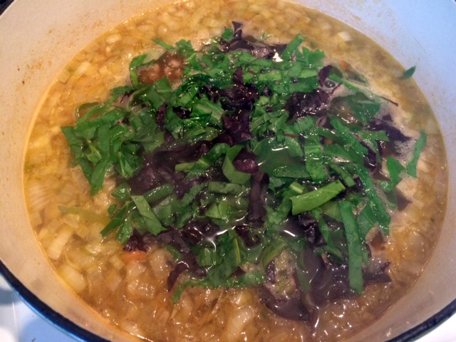 After adding the broth and cooked barley, toss in some chopped baby greens at the end.